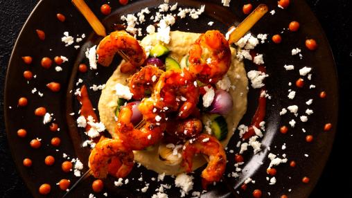 Grilled Harissa Shrimp Skewer with Hummus, Cucumber, Mint, Charred Onion, and Feta
